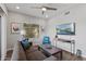 Cozy living room features a ceiling fan, a TV, a large window and comfortable seating at 475 N 9Th St # 206, Phoenix, AZ 85006