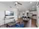 Modern living room with wood floors, a large tv and an open concept that leads to the kitchen at 475 N 9Th St # 206, Phoenix, AZ 85006