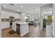 Open-concept living space with kitchen island, stainless appliances, wood flooring, and a view to the outside at 475 N 9Th St # 206, Phoenix, AZ 85006