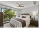 Comfortable main bedroom with a balcony access, ceiling fan and neutral decor at 475 N 9Th St # 206, Phoenix, AZ 85006