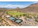 Capture the essence of the community with this aerial view of the park, playground, and sports facilities against a mountain backdrop at 5208 W Straight Arrow Ln, Phoenix, AZ 85083