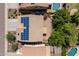 Stunning aerial view of a home with solar panels, pool, and lush landscaping, offering a private outdoor oasis at 5208 W Straight Arrow Ln, Phoenix, AZ 85083