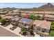 An aerial view shows a home in a residential neighborhood with mountain views and solar panels at 5208 W Straight Arrow Ln, Phoenix, AZ 85083