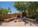 Charming backyard featuring an outdoor fireplace and a cozy seating area, perfect for entertaining guests at 5208 W Straight Arrow Ln, Phoenix, AZ 85083