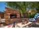 Close up of an outdoor fireplace with chairs and table, perfect for outdoor relaxation at 5208 W Straight Arrow Ln, Phoenix, AZ 85083