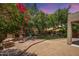 Paver-covered backyard features a built-in fireplace, seating, and a lush green lawn at 5208 W Straight Arrow Ln, Phoenix, AZ 85083