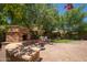 Spacious backyard with brick patio, fireplace and green area with mature trees, perfect for relaxation at 5208 W Straight Arrow Ln, Phoenix, AZ 85083