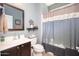 Bathroom with updated vanity, decorative mirror and coordinating shower curtain at 5208 W Straight Arrow Ln, Phoenix, AZ 85083