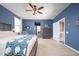 Spacious Primary bedroom with a dresser and king bed leading to an ensuite bathroom at 5208 W Straight Arrow Ln, Phoenix, AZ 85083
