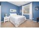 Cozy bedroom features cool paint and a large window, carpeted floor and white furniture at 5208 W Straight Arrow Ln, Phoenix, AZ 85083