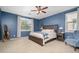 Primary bedroom with a king bed, nightstands, and an armchair, featuring natural light at 5208 W Straight Arrow Ln, Phoenix, AZ 85083
