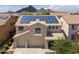 Two-story home showcasing solar panels, three-car garage and desert landscaping at 5208 W Straight Arrow Ln, Phoenix, AZ 85083