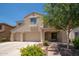 Charming two-story home with a three-car garage and inviting covered front porch at 5208 W Straight Arrow Ln, Phoenix, AZ 85083