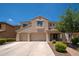 Inviting two-story home with three-car garage, manicured landscaping, and covered front porch at 5208 W Straight Arrow Ln, Phoenix, AZ 85083