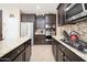 Gourmet kitchen features stainless appliances, granite counters and rich espresso cabinetry at 5208 W Straight Arrow Ln, Phoenix, AZ 85083