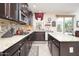 Updated kitchen with granite countertops, stainless steel appliances, and tile backsplash at 5208 W Straight Arrow Ln, Phoenix, AZ 85083