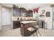 A stylish kitchen featuring granite countertops, dark cabinetry, and a functional center island at 5208 W Straight Arrow Ln, Phoenix, AZ 85083
