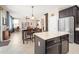 Open-concept kitchen with granite island counter, adjacent to dining and living areas at 5208 W Straight Arrow Ln, Phoenix, AZ 85083