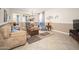 Comfortable living room featuring neutral colors, tile floors, and inviting furniture arrangement at 5208 W Straight Arrow Ln, Phoenix, AZ 85083