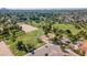 Expansive aerial view of a green community park featuring playgrounds, trees, and a community center building with parking at 5937 E Corrine Dr, Scottsdale, AZ 85254