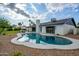 Backyard view of a pool and modern home with desert landscaping under a blue sky at 5937 E Corrine Dr, Scottsdale, AZ 85254