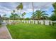 A beautiful backyard featuring lush green grass and manicured landscaping, enclosed by a tall white fence at 5937 E Corrine Dr, Scottsdale, AZ 85254