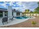 Backyard pool and patio with outdoor seating and landscaping on a sunny day at 5937 E Corrine Dr, Scottsdale, AZ 85254