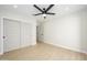 Cozy bedroom features modern ceiling fan, recessed lighting, and closet with sliding doors at 5937 E Corrine Dr, Scottsdale, AZ 85254