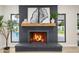 Elegant fireplace with a dark brick surround, complemented by stylish decor and natural light at 5937 E Corrine Dr, Scottsdale, AZ 85254
