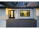 Charming front exterior featuring a modern door, large window, and beautiful landscaping creating a welcoming entrance at 5937 E Corrine Dr, Scottsdale, AZ 85254