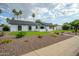 Inviting curb appeal featuring desert landscaping, lush green lawn, and a modern home design with stylish elements at 5937 E Corrine Dr, Scottsdale, AZ 85254