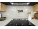 Kitchen cooktop with stainless steel range hood and decorative accents at 5937 E Corrine Dr, Scottsdale, AZ 85254