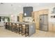 Bright kitchen featuring a large island with seating, stainless steel appliances, and ample cabinet space at 5937 E Corrine Dr, Scottsdale, AZ 85254