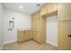 Bright laundry room featuring cabinets, countertop space, and a convenient washing machine hook-up at 5937 E Corrine Dr, Scottsdale, AZ 85254