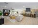 Bright open-plan living space featuring a fireplace, kitchen with bar seating, and neutral-toned decor at 5937 E Corrine Dr, Scottsdale, AZ 85254