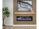 Stylish living room with modern fireplace, wood accent wall, mantle, and elegant decor at 5937 E Corrine Dr, Scottsdale, AZ 85254