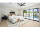 Bright main bedroom with a view of the pool through large sliding glass doors at 5937 E Corrine Dr, Scottsdale, AZ 85254