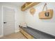 Charming mud room with built-in bench, drawers, and stylish hooks for storage and organization at 5937 E Corrine Dr, Scottsdale, AZ 85254