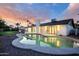 Backyard pool with a modern-style home and covered patio against a sunset backdrop at 5937 E Corrine Dr, Scottsdale, AZ 85254