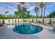 Backyard pool surrounded by desert landscaping and greenery on a sunny day at 5937 E Corrine Dr, Scottsdale, AZ 85254