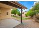 Landscaped backyard with manicured lawn, decorative plants, and a charming fountain at 6420 W Beverly Ln, Glendale, AZ 85306