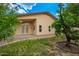Tan home exterior featuring a covered patio with double doors leading to the backyard at 6420 W Beverly Ln, Glendale, AZ 85306