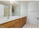 Well-lit bathroom featuring a large mirror, vanity with sink, and tile flooring at 6420 W Beverly Ln, Glendale, AZ 85306