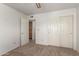 Comfortable bedroom with carpet, ceiling fan and closet, with an open door to the bathroom at 6420 W Beverly Ln, Glendale, AZ 85306