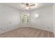 Neutral-toned bedroom with carpet, ceiling fan, window with shutters and decorative wall design at 6420 W Beverly Ln, Glendale, AZ 85306