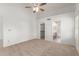 Bright bedroom offers neutral carpet, ceiling fan, closet and a bathroom with natural light at 6420 W Beverly Ln, Glendale, AZ 85306