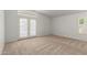 Light-filled bedroom with plush carpeting, a window, and french doors at 6420 W Beverly Ln, Glendale, AZ 85306