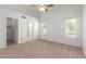 Spacious bedroom featuring neutral carpet, white walls, ceiling fan, and great natural light through shuttered windows at 6420 W Beverly Ln, Glendale, AZ 85306
