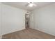 Cozy bedroom with neutral carpet, ceiling fan and an open doorway to the bathroom at 6420 W Beverly Ln, Glendale, AZ 85306