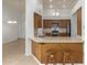 Open-concept kitchen features bar seating, wooden cabinets, and neutral countertops for a functional design at 6420 W Beverly Ln, Glendale, AZ 85306